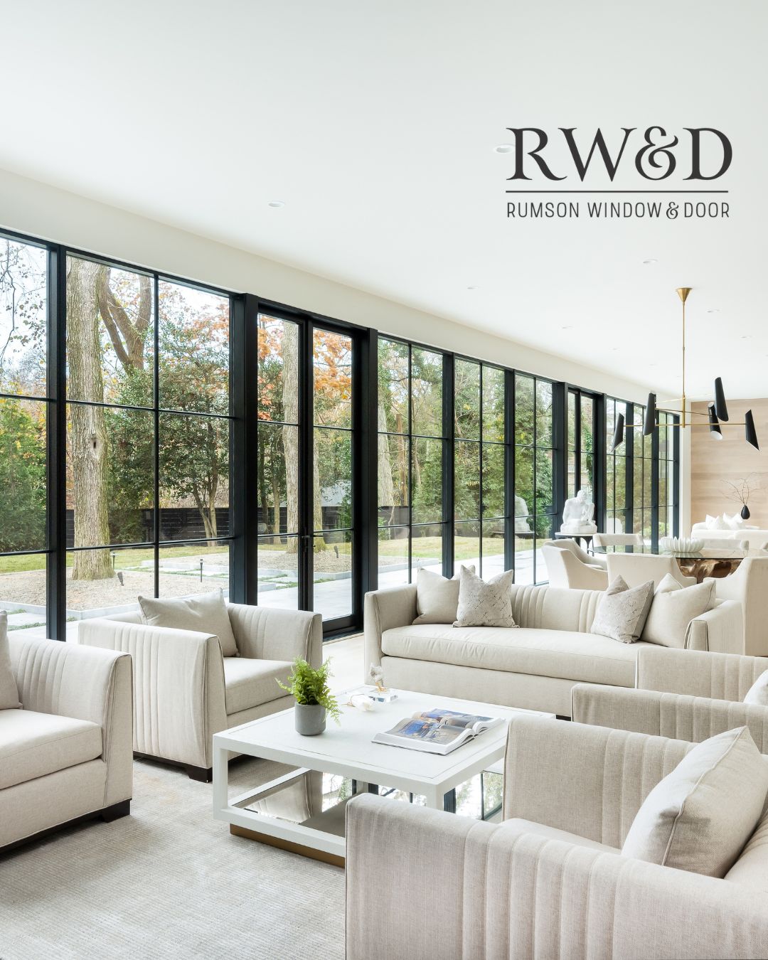 Rumson Window & Door branded social post of a living room with floor-to-ceiling black steel windows