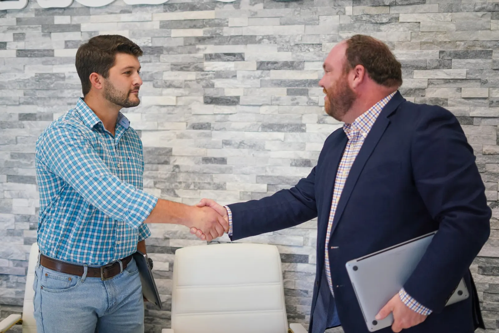 Waypoint Marketing team member shaking hands with a client after a strategy meeting